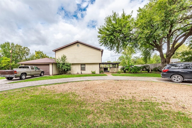 view of front of home with a garage and a front yard