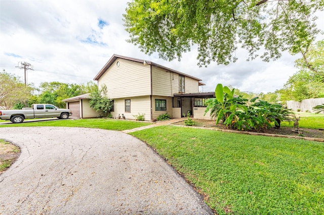 view of front of home featuring a garage and a front lawn