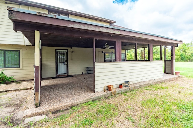 exterior space featuring ceiling fan and a front yard