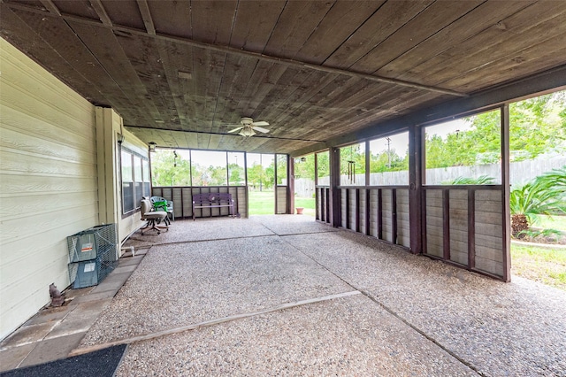 unfurnished sunroom featuring ceiling fan