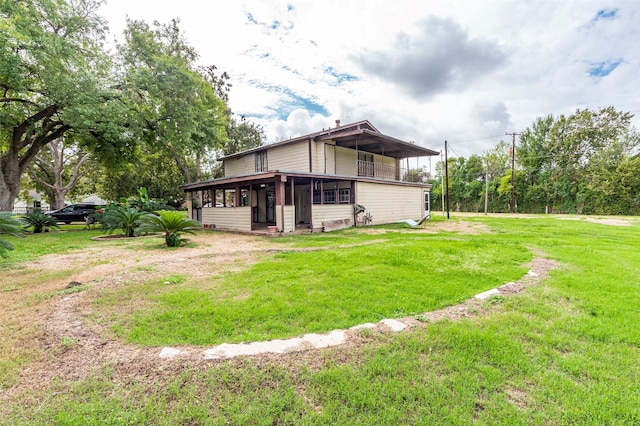 rear view of property with a lawn