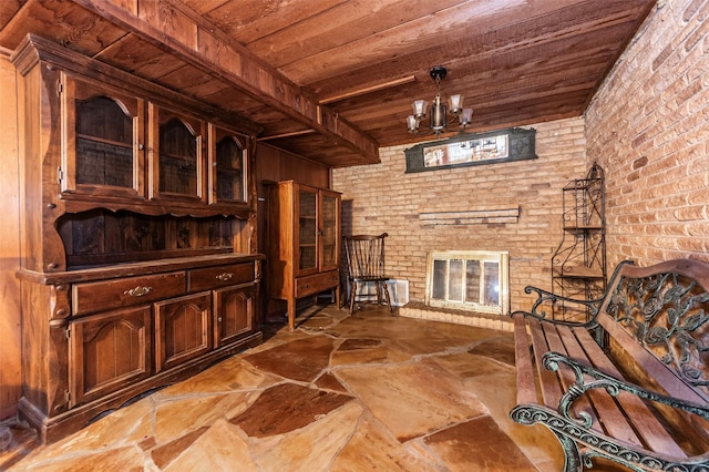 living area with an inviting chandelier, a fireplace, wooden ceiling, beamed ceiling, and wood walls