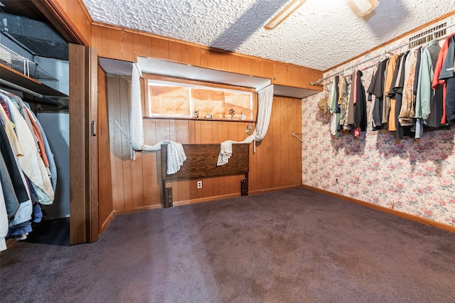 walk in closet featuring dark colored carpet