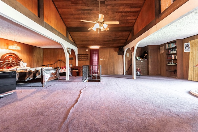 interior space featuring wood walls, light carpet, and wooden ceiling