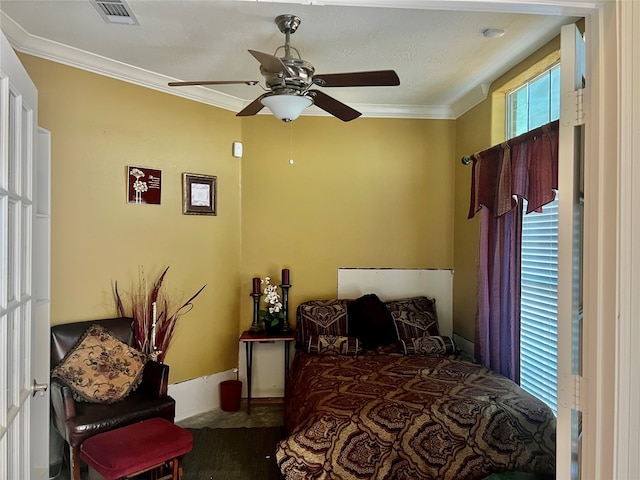 bedroom with ceiling fan and crown molding