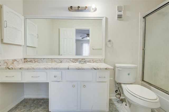 full bathroom with tile flooring, ceiling fan, enclosed tub / shower combo, toilet, and vanity