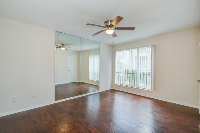 unfurnished room featuring ceiling fan and dark hardwood / wood-style floors