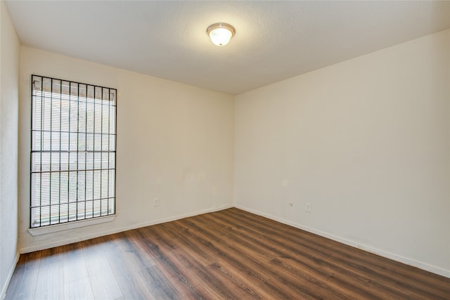 spare room featuring dark hardwood / wood-style flooring