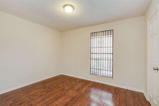 spare room featuring dark hardwood / wood-style floors