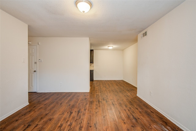 unfurnished room featuring dark hardwood / wood-style floors