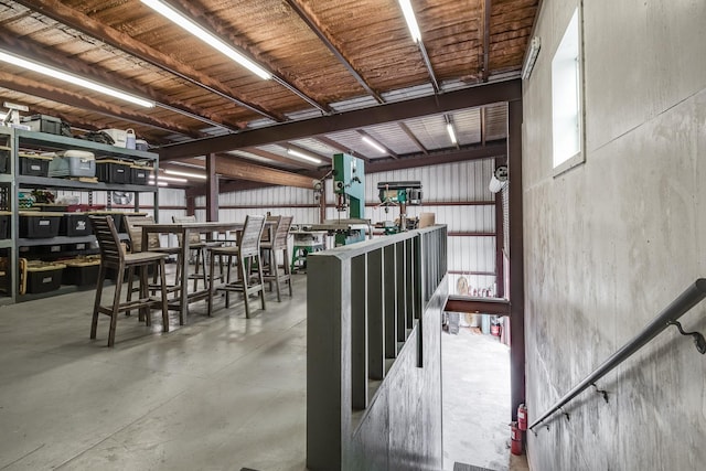 unfurnished dining area featuring concrete floors and metal wall