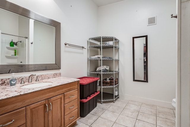 bathroom featuring a shower, visible vents, toilet, vanity, and tile patterned flooring