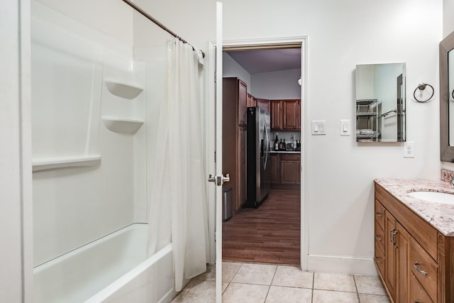 full bath featuring shower / tub combo with curtain, baseboards, vanity, and tile patterned floors