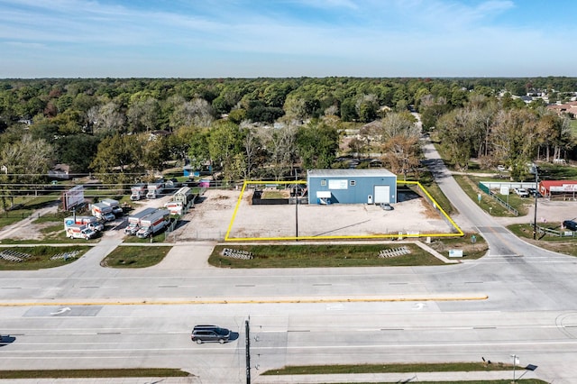 drone / aerial view featuring a forest view