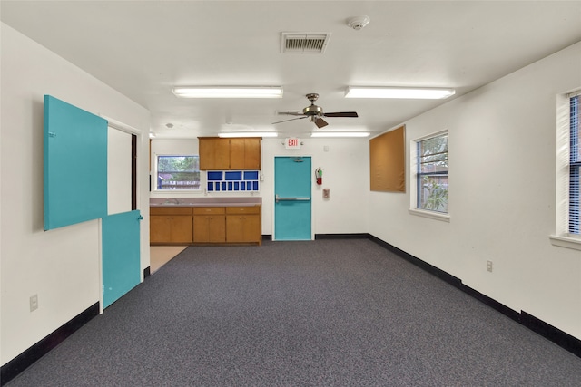 interior space with ceiling fan and sink