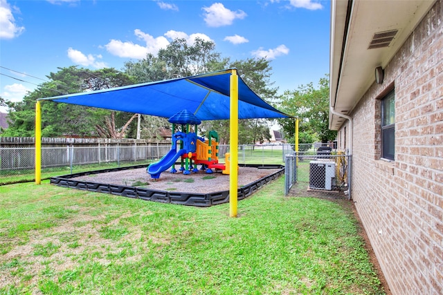 view of playground with a yard and central air condition unit