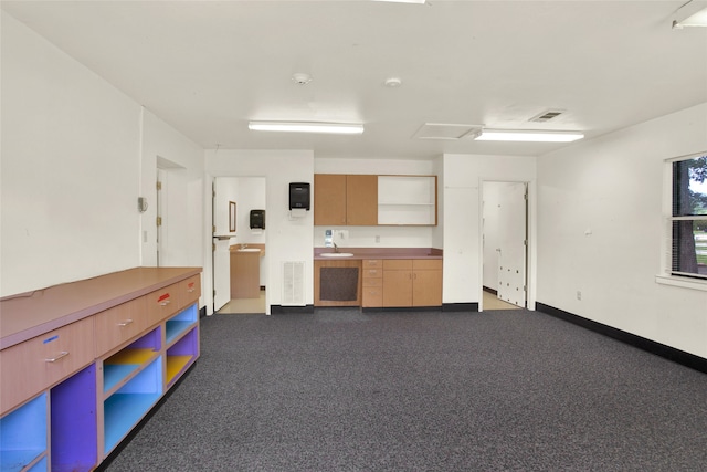 kitchen featuring dark colored carpet