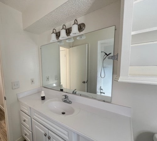 bathroom with oversized vanity and a textured ceiling