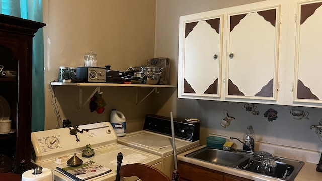 laundry room with independent washer and dryer and sink