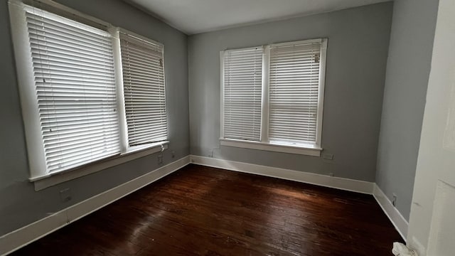 spare room with dark hardwood / wood-style flooring