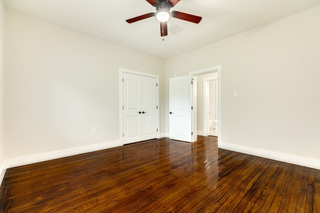 empty room featuring ceiling fan and dark wood-type flooring