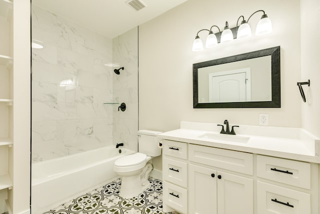 full bathroom featuring toilet, tile floors, tiled shower / bath combo, and vanity