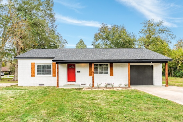 ranch-style house featuring covered porch, a front lawn, and a garage