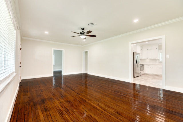 empty room with ornamental molding, plenty of natural light, ceiling fan, and light wood-type flooring