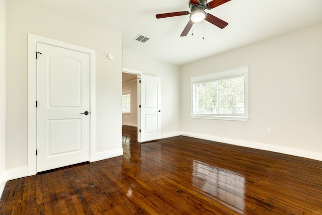 unfurnished room with ceiling fan and dark hardwood / wood-style flooring