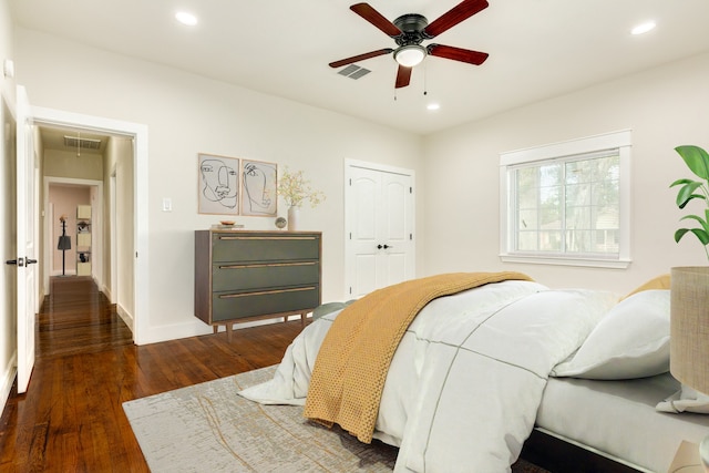 bedroom featuring dark hardwood / wood-style floors, a closet, and ceiling fan