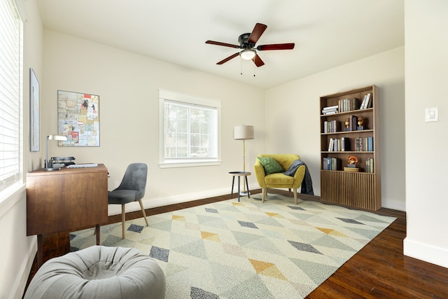 home office with ceiling fan and dark wood-type flooring