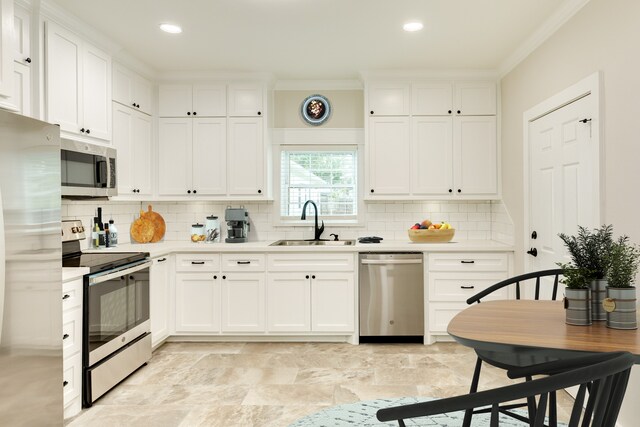 kitchen featuring stainless steel appliances, white cabinetry, and light tile floors