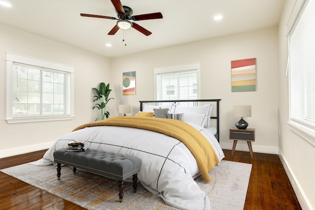 bedroom with dark hardwood / wood-style flooring and ceiling fan