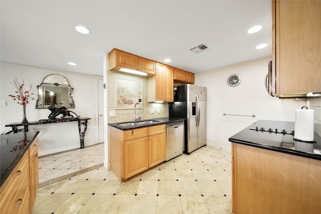 kitchen with appliances with stainless steel finishes, tasteful backsplash, sink, and light tile flooring