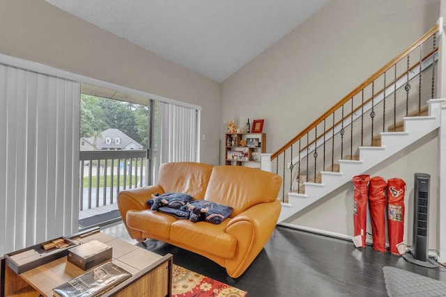 living room with dark hardwood / wood-style flooring and vaulted ceiling