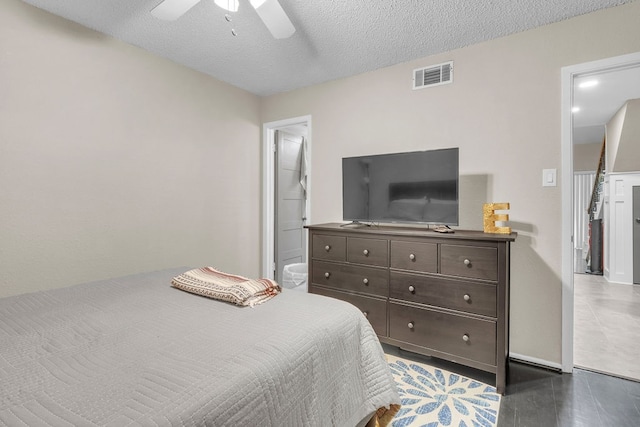 bedroom with ceiling fan and a textured ceiling