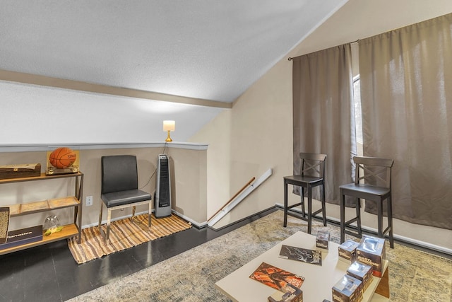 living room featuring a textured ceiling, wood-type flooring, and lofted ceiling