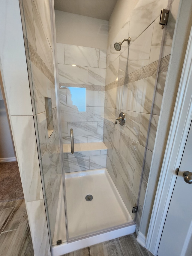 bathroom with walk in shower and hardwood / wood-style flooring