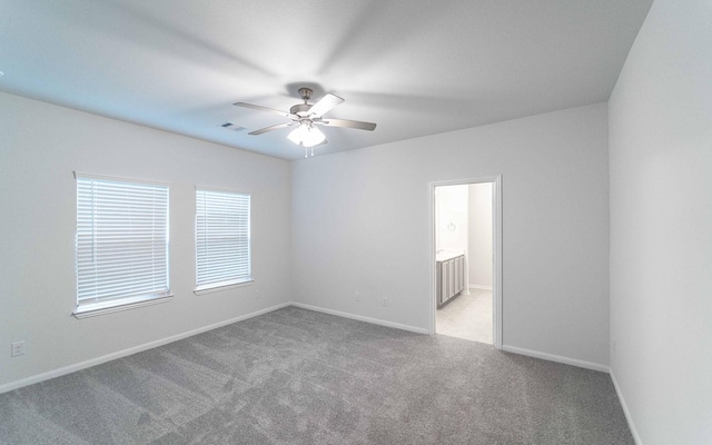 unfurnished room with light carpet and ceiling fan