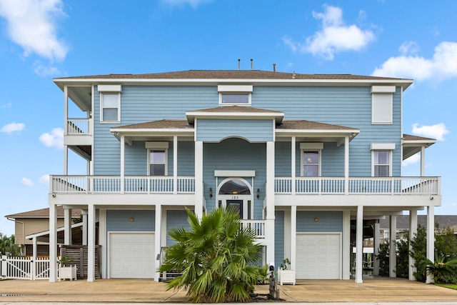 raised beach house with a balcony and a garage