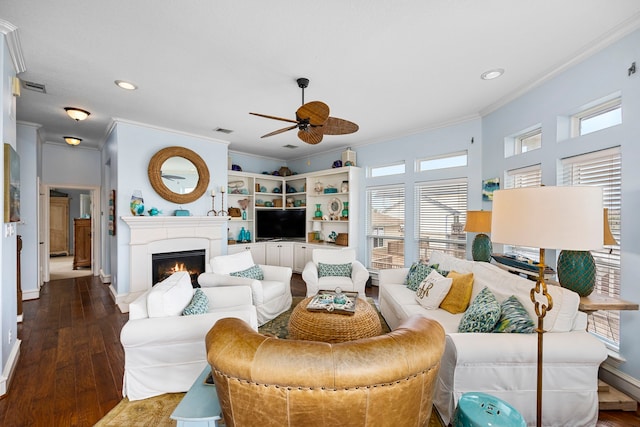 living room with hardwood / wood-style floors, ornamental molding, and ceiling fan