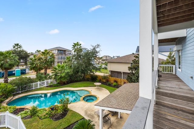 view of pool featuring an in ground hot tub, a deck, and a patio area