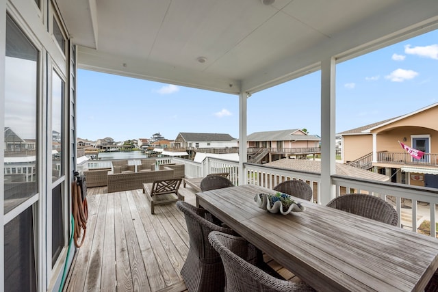 wooden deck featuring a water view