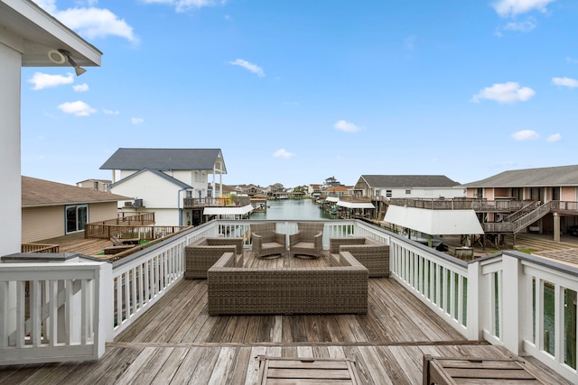 wooden deck featuring an outdoor hangout area and a water view