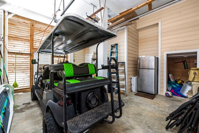 garage with stainless steel fridge