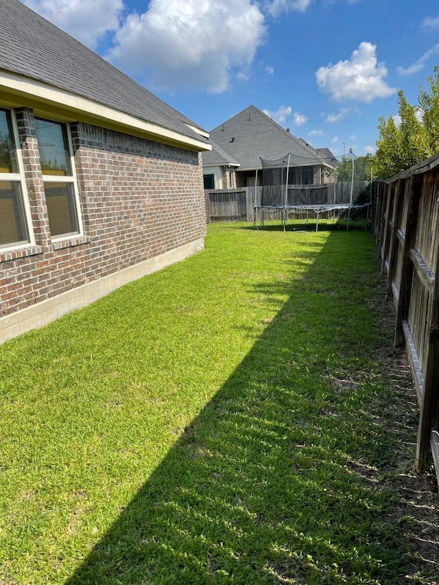 view of yard with a trampoline