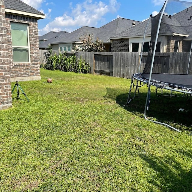 view of yard with a trampoline