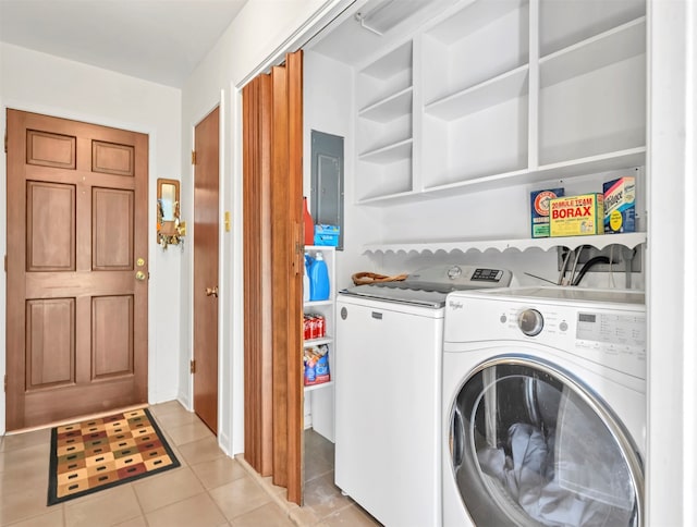 laundry area with light tile flooring and washing machine and dryer