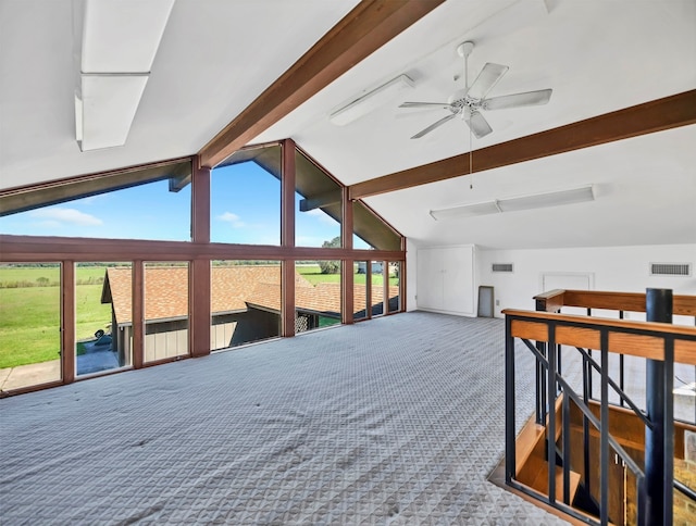 interior space featuring access to exterior, ceiling fan, vaulted ceiling with beams, and multiple windows