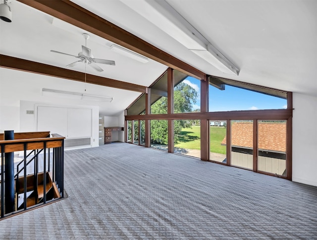 interior space featuring ceiling fan and lofted ceiling with beams